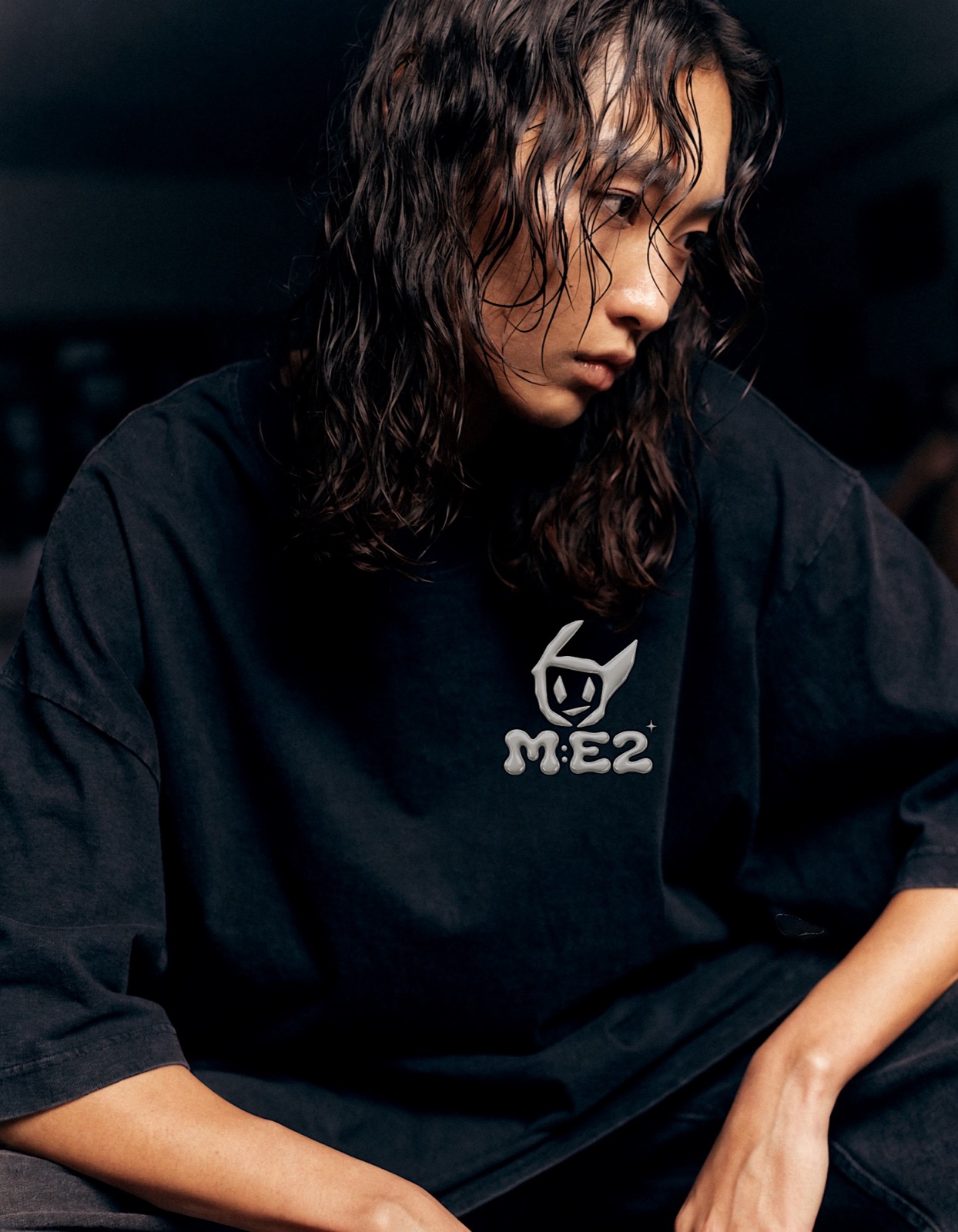Fashion editorial figure in a dark atmospheric setting